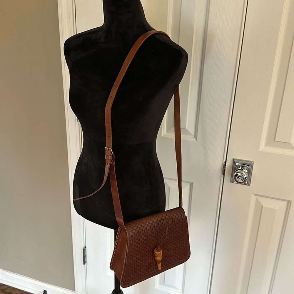Handmade leather crossbody. Brown leather with peg wooden closer